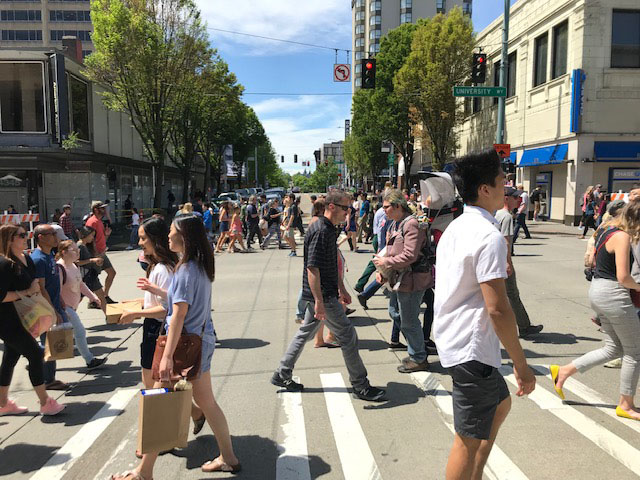 Pedestrians walking in the crosswalk on 45th and University Way